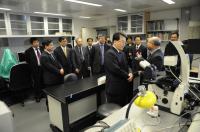 Prof. Kenneth K.H. Lee (2nd from right) introducing the core facilities to the delegation
